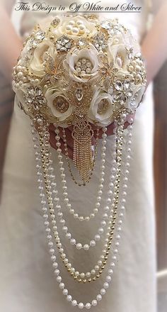 the bridal bouquet is adorned with pearls and flowers