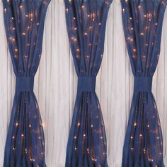 the curtains are decorated with lights and ribbons