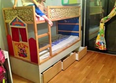 a child is sitting on top of a bunk bed in a room with wooden floors