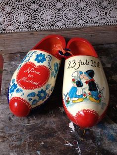 two red and white shoes with mickey mouse painted on the bottom one is for sale