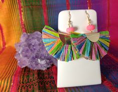 Handmade Earrings Womens Boho Lightweight Large fan shaped RAFFIA earrings in colorful neons pink blue green yellow in gold tone with pink sugar bead. 2.5 inches long 2 3/4 wide. Everyone LOVES these handmade earrings... FABULOUS LIGHTWEIGHT. Easy to wear comfortable. HANDMADE by me...ARTIST CARRIE WHITE. Great for Women and Girls. Earwire is stainless steel hypoallegenic. Excellent gift. Super high quality. Easy to wear casual chic vintage for the disco sporting life. **Please note the color di Multicolor Festive Jewelry For Summer, Funky Multicolor Earrings For Parties, Pink Bohemian Party Earrings, Multicolor Bohemian Earrings For Fiesta, Vibrant Multicolor Party Earrings, Vibrant Pink Earrings For Festivals, Vibrant Pink Handmade Earrings, Handmade Vibrant Pink Earrings, Multicolor Bohemian Hand-strung Earrings