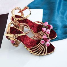 The Lucy Floral Heels are the ultimate in elegance with vintage vibes. They are perfect for day and night, beautifully handcrafted in velvet decorated with flowers and beads. The main attraction is unique birdcage heels. Wear it with an elegant dress and you are good to go. Specifications: Side Vamp Type: Open Heel Height: High (5cm-8cm) Closure Type: Buckle Strap Back Counter Type: Front & Rear Strap Fashion Element: Flower Pattern Type: Floral Handmade *** Fits true to size, take your normal s Gold Ankle Strap Wedding Shoes For Spring, Gold High Heel Wedding Shoes For Spring, Gold Open Toe Wedding Shoes For Spring, Summer Wedding Shoes In Gold For Events, Gold Wedding Shoes For Summer Events, Floral Embellished Open Toe Heels For Evening, Elegant Festive Heels For Party, Elegant Party Heels For Festive Occasions, Festive Wedding Shoes With Round Toe For Party