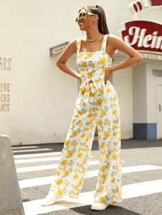 Allover Lemon Print Belted Jumpsuit is perfect for the free-spirited boho look, it features a fun and fresh fruit and vegetable all-over print with a comfortable and loose fit. The high-waist cut elongates your legs, while the belted waist cinches you in for a flattering silhouette. The zipper detail adds a touch of practicality, and the non-stretch fabric keeps its shape wash after wash. Perfect for any occasion, from picnics to festivals. Get ready to turn heads with this unique piece, exclusively from Comfy Jumpsuits. Specifications: Style: Boho Pattern Type: Fruit & Vegetable, All Over Print Type: Cami Details: Belted, Zipper Length: Long Fit Type: Loose Neckline: Straps Sleeve Length: Sleeveless Waist Line: High Waist Fabric: Non-Stretch Material: Fabric Composition: 100% Polyester Ca Comfy Jumpsuits, Belted Jumpsuit, Belt Jumpsuit, Lemon Print, Boho Patterns, Boho Look, Zipper Detail, Cinched Waist, Free Spirit