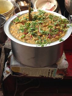 a large pot filled with lots of food on top of a table