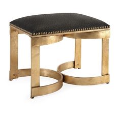 a gold colored bench with black cushion on it