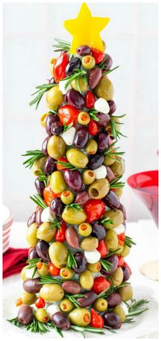 a christmas tree made out of olives and peppers