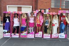 a group of women standing next to each other in front of a store display case