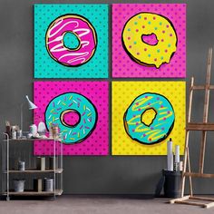 three paintings of donuts on different colored squares