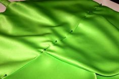 the green fabric is folded up and ready to be sewn