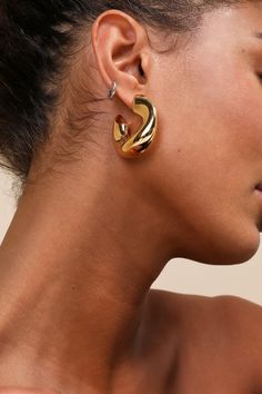 Raise the wow factor on your next date night when you wear the Lulus Gorgeous Effect Gold Chunky Hoop Earrings! Shiny, gold-toned metal shapes these substantial, hoop-style earrings that have a confident presence that's perfect for adding an in-charge finish to all your most sophisticated looks. Post backs. 1. 25" Diameter. 100% Brass. Imported. Lulus | Gorgeous Effect Gold Chunky Hoop Earrings. Gold Statement Earrings Formal, Black Dress Gold Jewelry, Gold Chunky Earrings Aesthetic, Earring Product Photography, Gold Hoops Chunky, Trendy Gold Chunky Hoop Earrings, Chunky Gold Statement Earrings, Golden Chunky Earrings, Chunky Gold Earrings