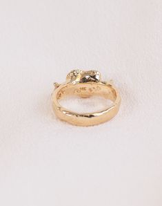 a gold ring with two diamonds on it