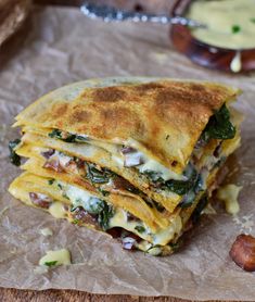 a stack of quesadillas sitting on top of a piece of wax paper