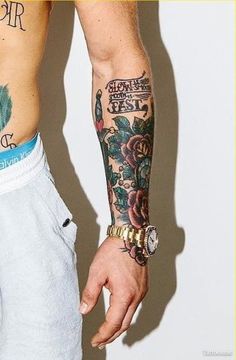 a man with many tattoos on his arm