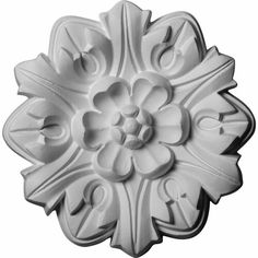 a white flower shaped cookie mold on a white background with the word love spelled below it