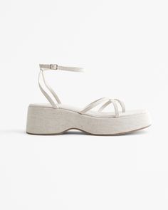 Our new slip-on platform heels in a soft vegan leather fabric with an adjustable ankle strap and on-trend platform base. Perfect to dress up or down! Upper Width: 3 in. Platform Height: 2.625 in. Aesthetic Shoes, Abercrombie And Fitch, Leather Fabric, Platform Heels, Abercrombie Fitch, Women's Shoes Sandals, Gray White, Gender Female, Ankle Strap