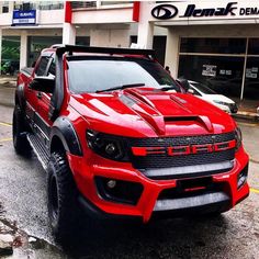 a red truck parked in front of a building