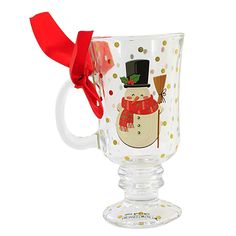 a frosty glass mug with a red bow on the handle and snowman design