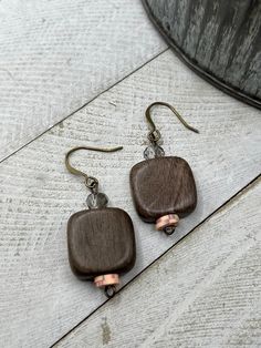 Lightweight wooden square beads mixed with tiny sparkle gray and coral colored beads. These beauties dangle from antique bronze nickel free ear wires. Handmade Square Brown Jewelry, Handmade Brown Square Jewelry, Brown Rectangular Bohemian Earrings, Bohemian Brown Rectangular Earrings, Handmade Wooden Earrings For Everyday, Handmade Wooden Earrings For Everyday Wear, Everyday Handmade Wooden Earrings, Handmade Wooden Dangle Jewelry, Minimalist Brown Rectangular Jewelry