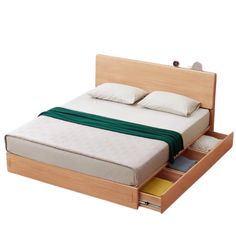 a bed with two drawers underneath it and a green blanket on top of the bed