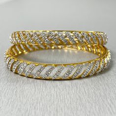 The Curves Bangles Set is inspired and created to reflect Indian tradition and design. With diamonds studded in a yellow gold, these bangles exude an ethereal glow. Total Diamond Weight: 7.70 ct No. of Diamonds: 400Diamond Color: G - HDiamond Clarity: VS Metal: 18K Yellow GoldMetal Wt: 34.46 gms Setting: Prong Set Inner Diameter: 2.4 Inches (6.10 cm) Yellow Gold Diamond Bangle Bracelet With Sparkling Stones, Yellow Gold Diamond Bangle With Sparkling Stones, Yellow Gold Diamond Bracelet With Sparkling Stones, Gold Diamond Cut Dazzling Bracelet, Gold Diamond Cut Bracelet With Dazzling Style, Dazzling Gold Diamond Cut Bracelet, Gold Sparkling Diamond Bracelet, Gold Diamond Bracelet With Sparkling Detail For Anniversary, Gold Sparkling Diamond Bracelet For Anniversary