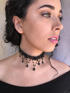 Black is beautiful in this Classic color. This is a hand beaded choker made with hand painted resin flowers and constructed with glass beads on a sturdy fabric backing. With seven handbeaded swags hanging down. A smashing black choker that will get you noticed. This is a quality piece of jewelry that will last a life time. Created by designer Colleen Toland who has been creating her unique style of vintage jewelry for more than 30 years. All of our pieces come with an engraved tag with Colleen's Party Choker With Dangling Beads, Adjustable Beaded Necklaces For Party With Bead Caps, Festival Beaded Dangle Choker, Painted Resin, Pirate Costume, Black Choker, Resin Flowers, Choker Necklaces, Life Time