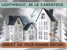 there is a paper cutout of houses with trees on the front and bottom, which reads great as year - round decor