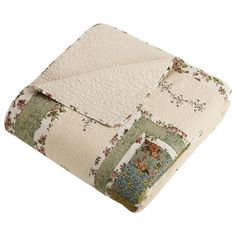 a quilted blanket with floral designs on the bottom and sides is folded in two rows