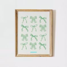 a framed painting with green bows on it