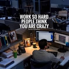 a man sitting at a desk in front of two computer monitors with the caption work so hard people think you are crazy