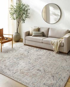 a living room with a couch, chair and mirror