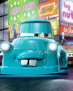 a blue car with big eyes on the street