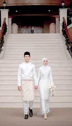 a man and woman standing in front of some stairs