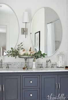 a bathroom with two sinks and mirrors on the wall