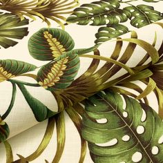 a green and white tropical print fabric