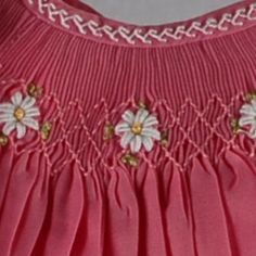 a pink dress with white flowers on it