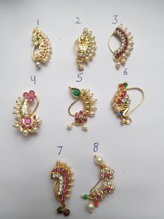 several different types of brooches are shown on a white surface with numbers in the bottom right corner