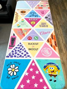 a table covered in colorful magnets and stickers on top of a wooden floor