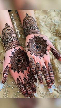 two hands with henna designs on them