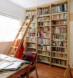 a room with a ladder and bookshelf full of books