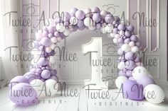 the number one balloon arch is decorated with purple and white balloons