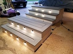 some steps with lights on them in a garage