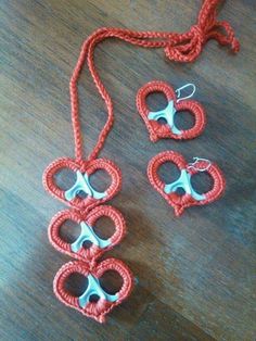 crocheted necklace and earring set with scissors on wooden table top next to string