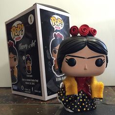 the pop vinyl figure is in front of a box