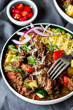 a white bowl filled with meat and vegetables