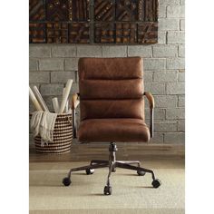 a brown office chair sitting in front of a brick wall