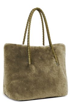 Carry your essentials in style with this luxe tote crafted from plush genuine shearling and fashioned with multiple pockets for maximum organization. Magnetic-snap closure Top carry handles Interior wall pockets; water bottle pocket; key fob Lined Genuine shearling (India) Imported Luxury Faux Fur Shoulder Bag With Fur Lining, Luxury Faux Fur Shoulder Bag, Luxury Bags With Faux Fur Lining For Winter, Luxury Faux Fur Shoulder Bag For Everyday Use, Luxury Faux Fur Bags For Everyday Use, Luxury Faux Fur Bag For Everyday Use, Luxury Sheepskin Bags With Faux Fur Lining, Luxury Faux Fur Rectangular Shoulder Bag, Luxury Rectangular Faux Fur Shoulder Bag