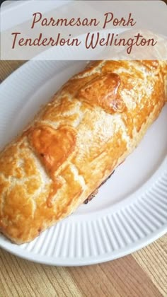 a white plate topped with a pastry on top of a wooden table