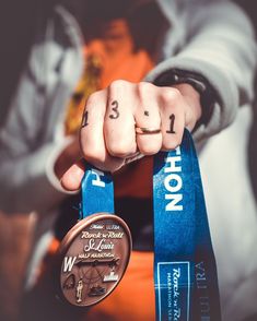 a person holding two medals in their hands