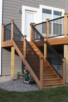 an outside view of a house with stairs and railings