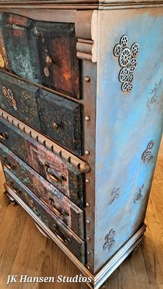 an old dresser is painted blue and silver